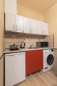 a kitchen with a stove and a washing machine at Deluxe Studios City Center in Burgas City