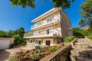 a house with balconies and flowers in front of it at Vila Tatjana in Klenovica