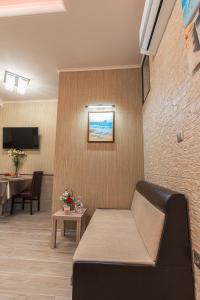 a waiting room with a couch and a table at Deluxe Studios City Center in Burgas City