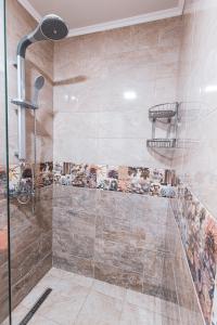 a bathroom with a shower with a glass door at Deluxe Studios City Center in Burgas City +47 photos