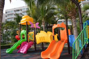 a playground in a park with colorful play equipment at Maldives Laguna Beach Resort 3 in Jomtien Beach