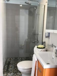 a bathroom with a toilet and a sink and a shower at Summer Studio - Zakynthos!! in Argassi +5 photos