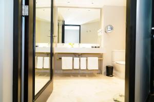 a bathroom with a sink and a mirror at Barceló Mexico Reforma in Mexico City