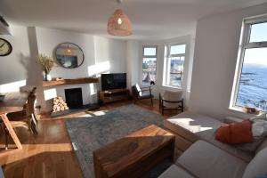 a living room with a couch and a table at The Promenade, Portstewart in Portstewart
