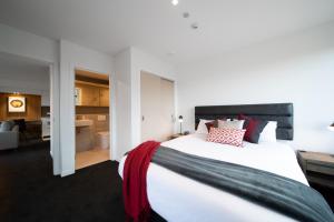 a bedroom with a large bed and a living room at Coronet Apartment, Complete comfort and views in Queenstown