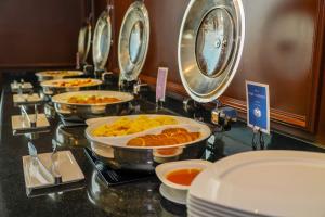 a buffet with many plates of food on a counter at Barceló Mexico Reforma in Mexico City