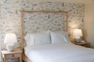 a bedroom with a bed with two lamps on tables at Russelltown Inn in Bonavista