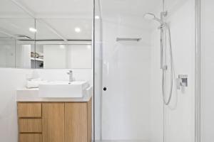 y baño con lavabo y ducha. en Kirra Palms Holiday Apartments, en Gold Coast