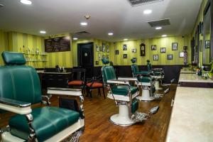 a salon with green chairs and a barber shop at Barceló Mexico Reforma in Mexico City