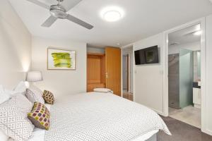 a bedroom with a bed and a ceiling fan at Frewville 7 Apartment in Mount Gambier