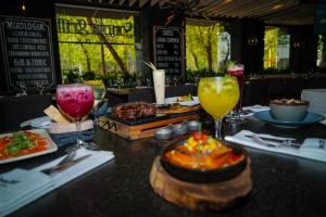 a table with plates of food and glasses of drinks at Barceló Mexico Reforma in Mexico City