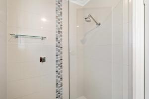 a bathroom with a shower with a glass door at City Two Apartment in Mount Gambier +12 photos