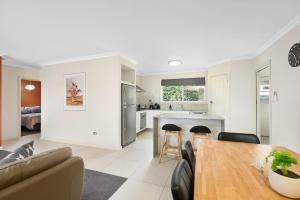 a kitchen and living room with a table and chairs at City Two Apartment in Mount Gambier