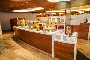 a restaurant with a counter with food on it at Barceló Mexico Reforma in Mexico City