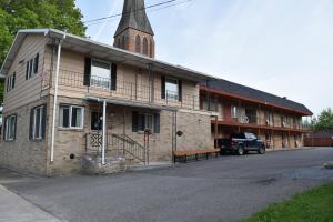 an old brick building with a church steeple at Mid-City Motel in Sault Ste. Marie