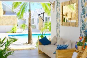 a living room with a couch and a swimming pool at So KohKoon Beach Resort in Bang Rak Beach