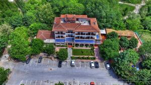 una vista aérea de una casa grande con coches aparcados en un aparcamiento en Nefeli Hotel, en Kozani