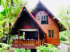 a small wooden house with a balcony in a forest at Starbay Samui in Koh Samui 
