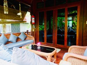 a porch with a couch and a coffee table at Starbay Samui in Koh Samui 