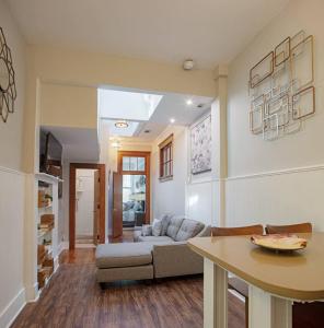 a living room with a couch and a table at 101 E Waldburg - Cozy Cottage just off of Forsyth Park in Savannah