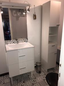 a bathroom with a sink and a mirror at studio saint lary au pla d'adet in Saint-Lary-Soulan