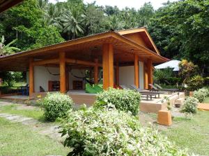 a house with a pavilion in a garden at Two Fish Resort Lembeh in Bitung