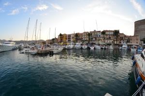 a bunch of boats are docked in a harbor at Hôtel Méditerranée in Calvi