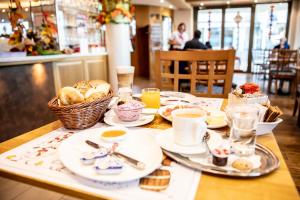 a table topped with plates of food and drinks at Gasthof zum Hecht in Fehraltorf