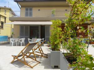 a patio with chairs and tables in front of a house at Il Fiore di Monnalisa in Vinci