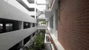 an empty hallway with plants and a brick wall at BS City Homestay1 - Miri Times Square in Miri