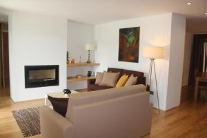 a living room with a couch and a fireplace at Quinta de Fiães - Agroturismo in Vilar de Maçada