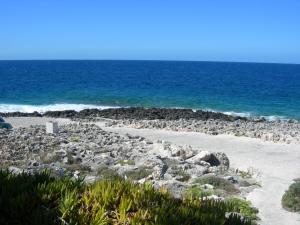 a beach with rocks and the ocean in the background at STERNES house in Agios Leon
