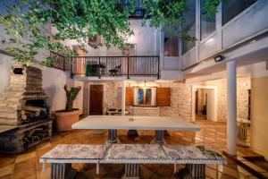 a table in the middle of a room with a fireplace at Heritage Residence in Center with pool in Vodice