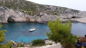a boat in a body of water with a group of people at STERNES house in Agios Leon