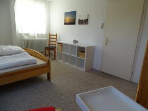 a bedroom with a bed and a desk and a chair at Der Ferienhof am Meer in Fehmarn