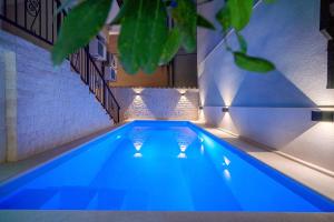 a swimming pool with blue lighting in a house at Heritage Residence in Center with pool in Vodice