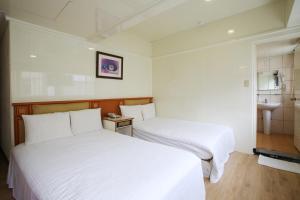 Postel nebo postele na pokoji v ubytování Lion Hotel