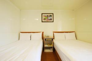 Postel nebo postele na pokoji v ubytování Lion Hotel