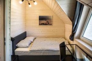 a small bedroom in a tiny house at Villa Baltica in Niechorze