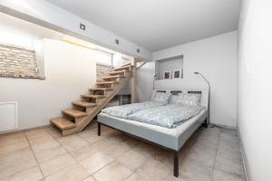 a bedroom with a bed and a staircase at Angel House Vilnius, Dysnos in Vilnius