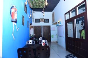 a dining room with blue walls and a table and chairs at Nutz Backpackers in Amritsar