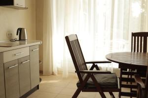 a kitchen with a table and a chair and a table and a window at Delfin in Koblevo