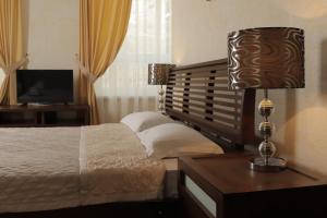 una camera con letto e tavolo con lampada di Delfin a Kobleve