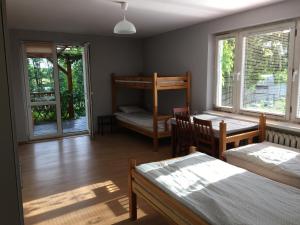 a bedroom with two beds and a bunk bed at Noclegi Tulipan in Konin