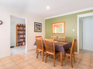 a dining room with a table and chairs at 1 54 Parkes Street in Tuncurry