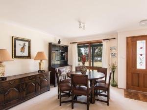 a dining room with a table and chairs at 11 Bay Street - waterfront holiday in Tuncurry