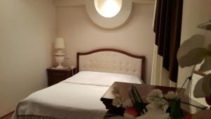 1 dormitorio con 1 cama con mesa y ventana en Hotel Geolog, en Surgut