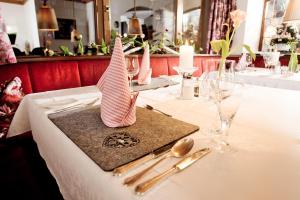 a table with a white table cloth with pink napkins at Kirchenwirt in Reith im Alpbachtal +75 photos