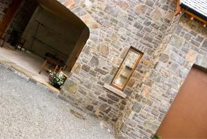 a brick building with a window and a wooden table at Courtyard Mews Armagh City in Armagh +9 photos