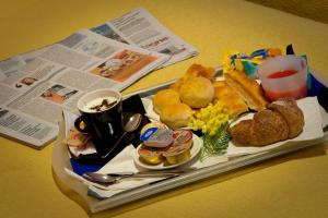 a tray of breakfast food on a table at Hotel Boccascena in Genoa